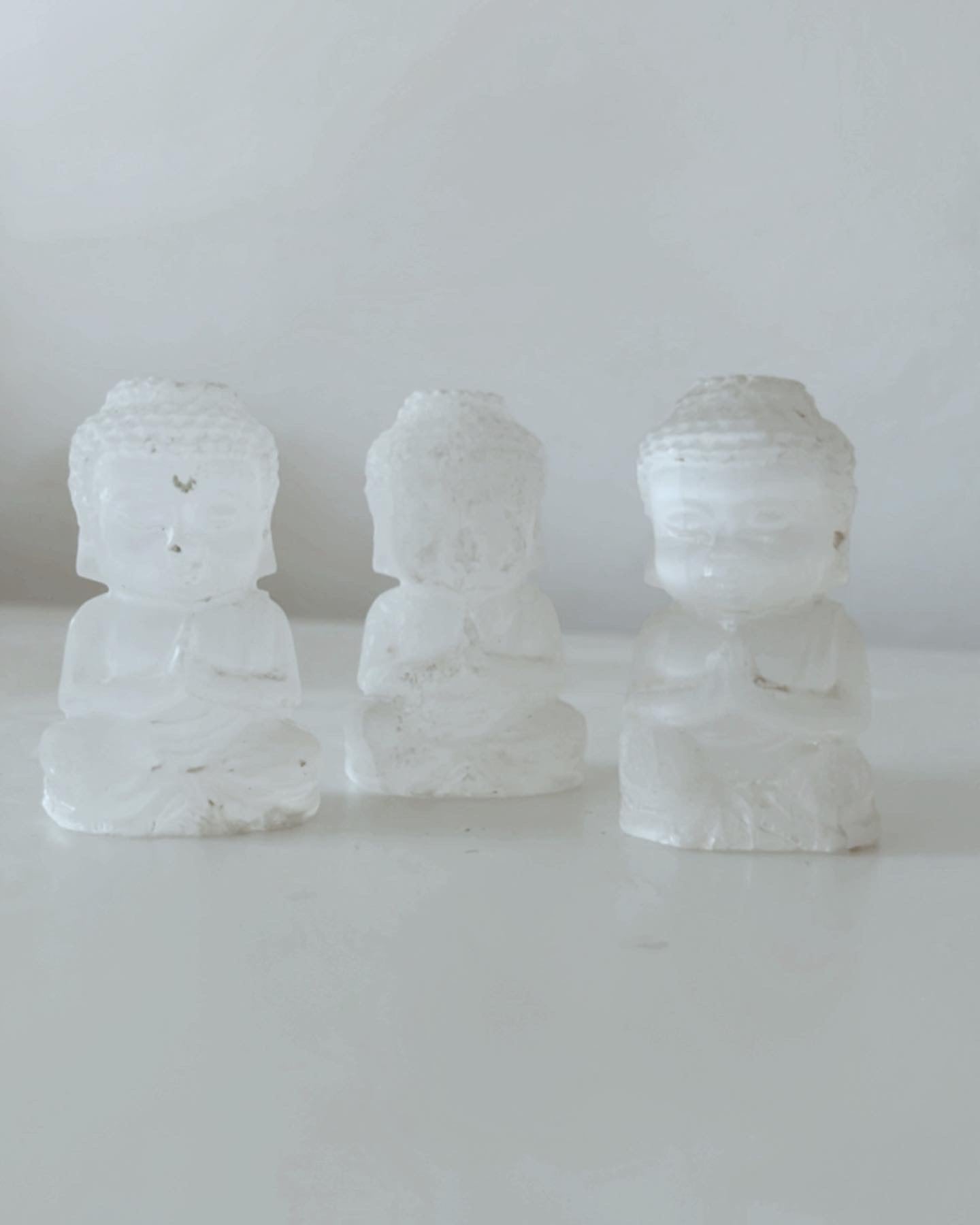 Selenite praying Buddhas